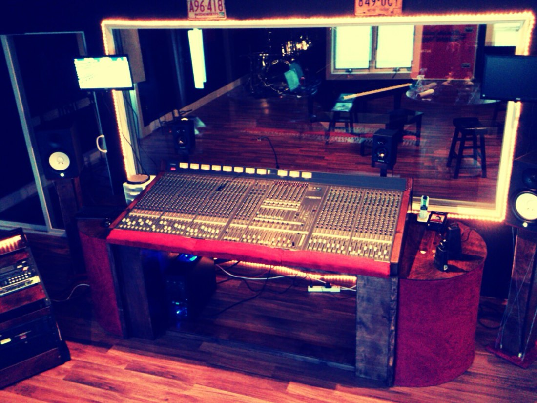 Recording studio control room mixing console, illustrating songs used to train AI music models