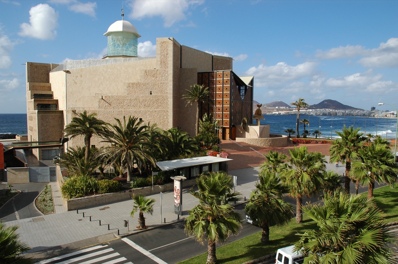 The Auditorio Alfredo Kraus in Las Palmas de Gran Canaria, a stone concert hall built at the edge of the beach against the Atlantic.