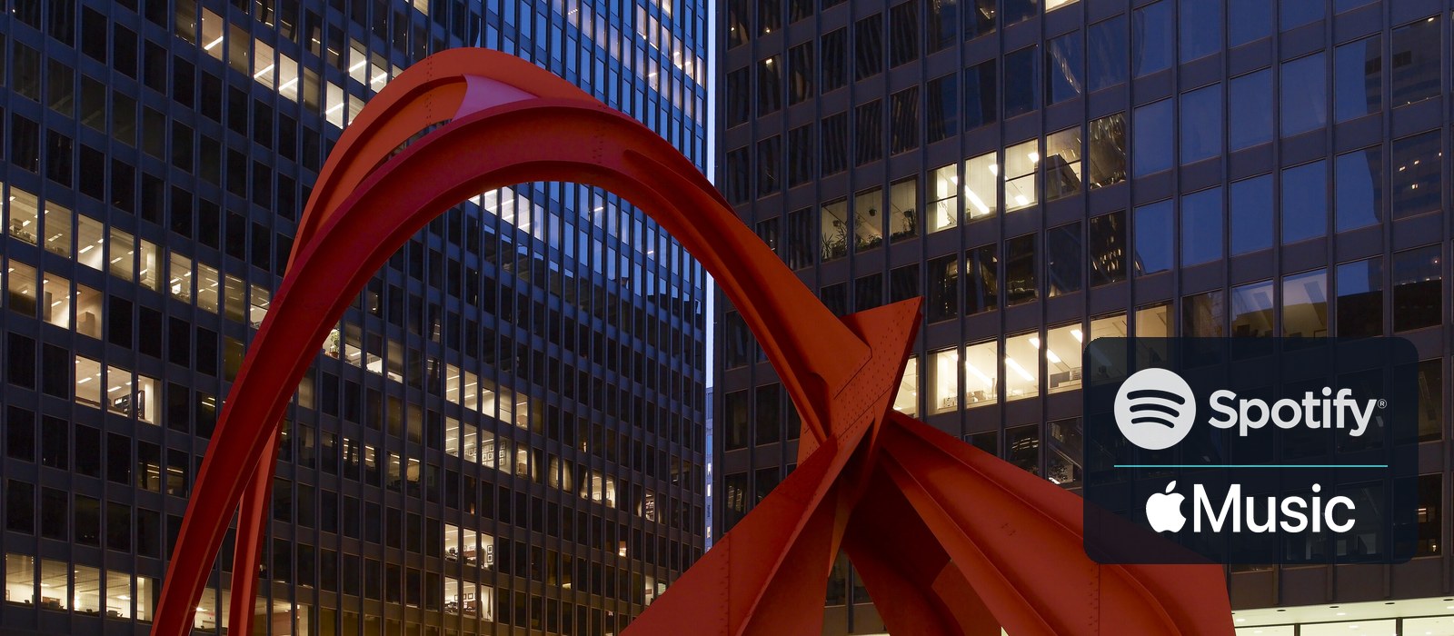 Alexander Calder's Flamingo sculpture at Chicago's Federal Plaza at dusk, with Spotify and Apple Music logos