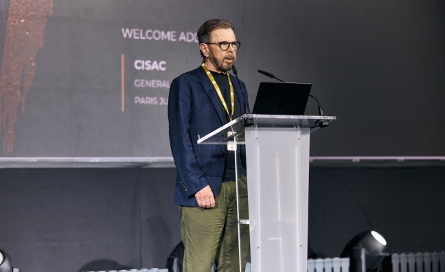 CISAC President Bjorn Ulvaeus speaks at a podium during the CISAC General Assembly in Paris