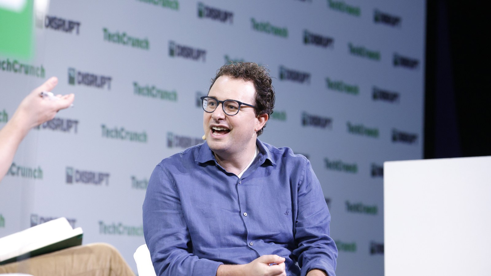 Anthropic co-founder Dario Amodei speaking on stage at TechCrunch Disrupt, now named in the publishers' direct infringement claim