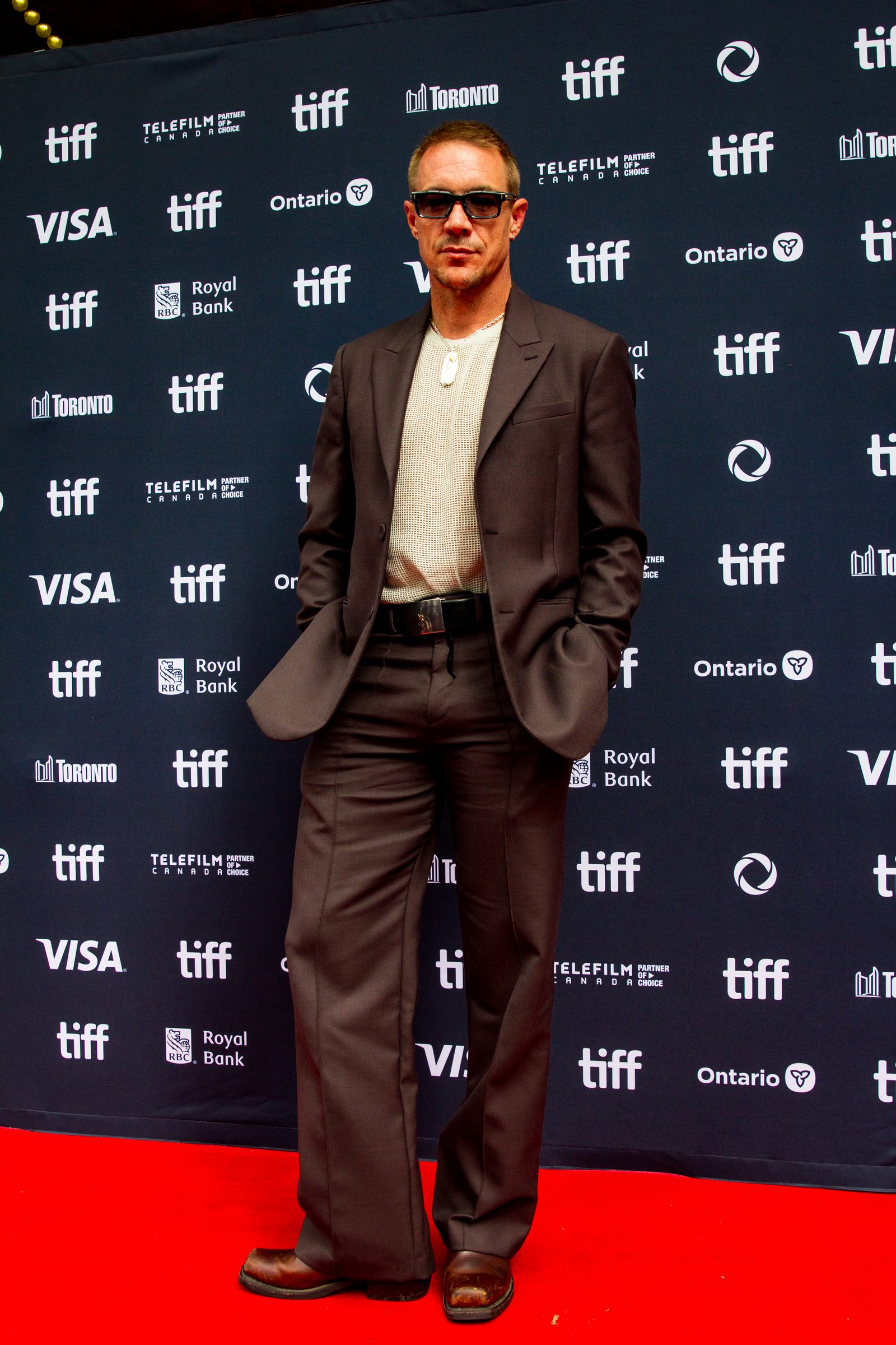 Diplo in a brown suit and sunglasses on the TIFF red carpet 2024