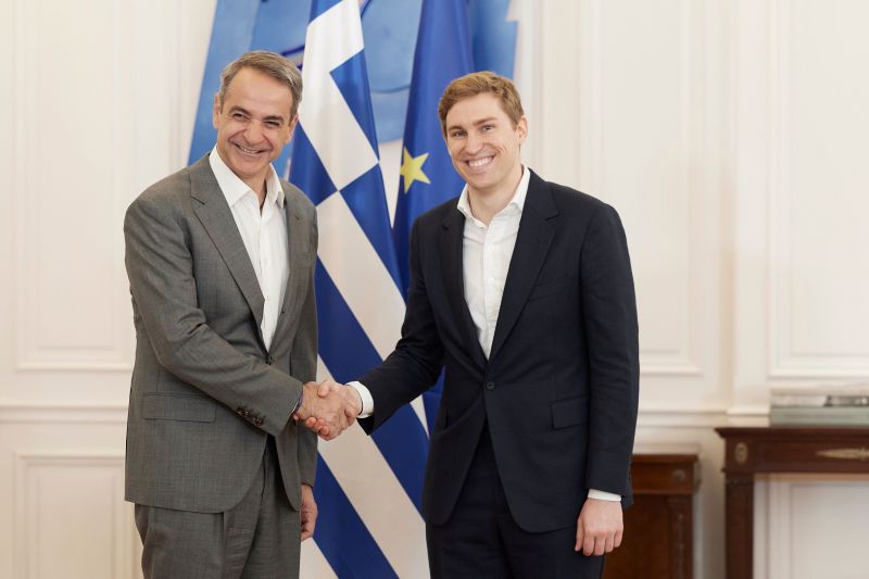 ElevenLabs cofounder Mati Staniszewski shaking hands with Greek Prime Minister Kyriakos Mitsotakis in Athens