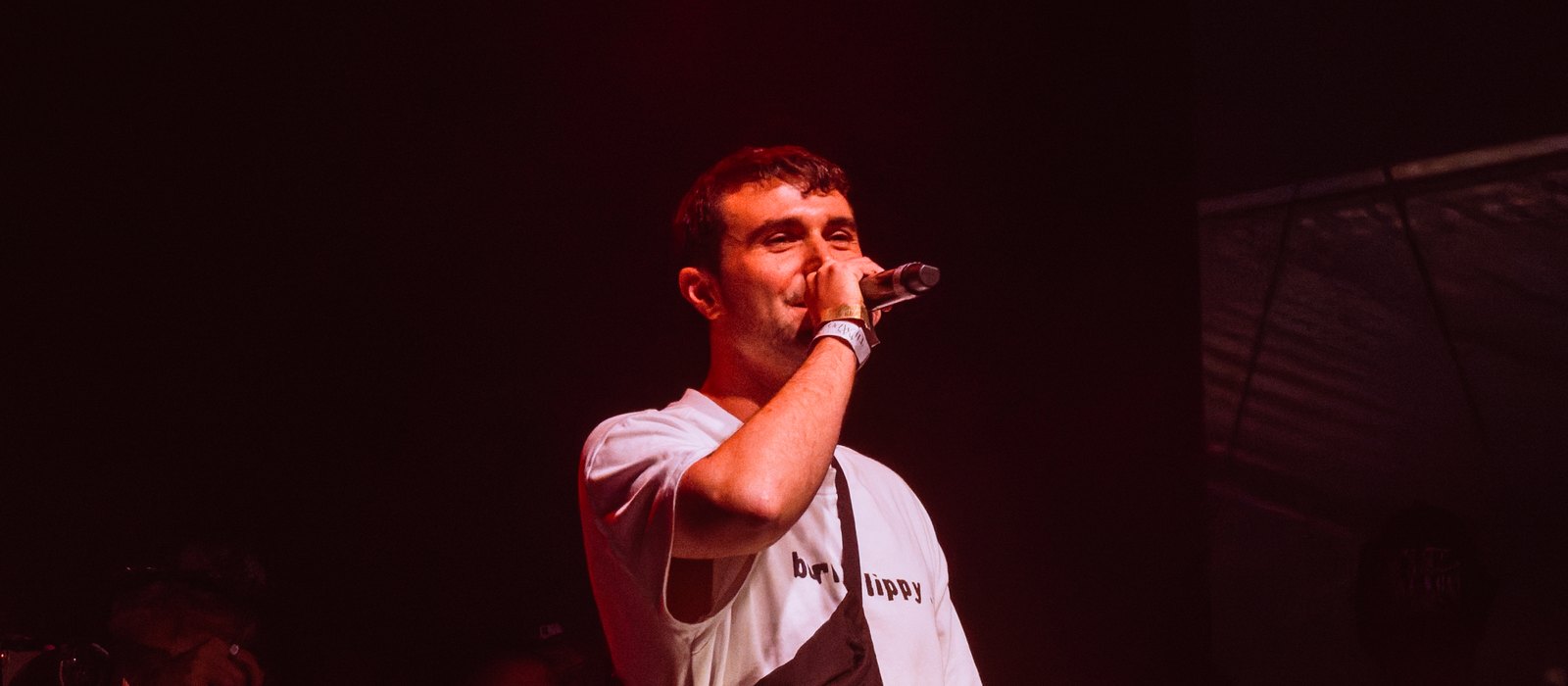 Fred again.. performing with a microphone during his set at Crystal Palace Bowl in London in August 2025