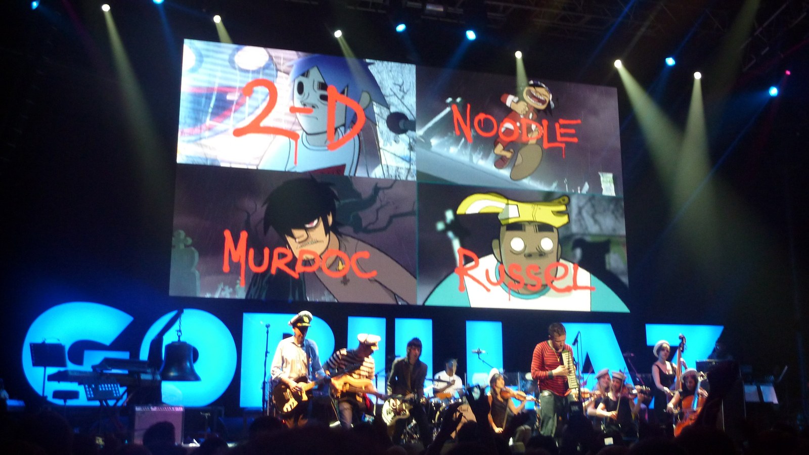 Gorillaz perform live on the 2010 Plastic Beach tour with 2-D, Noodle, Murdoc and Russel named on the screen above the band