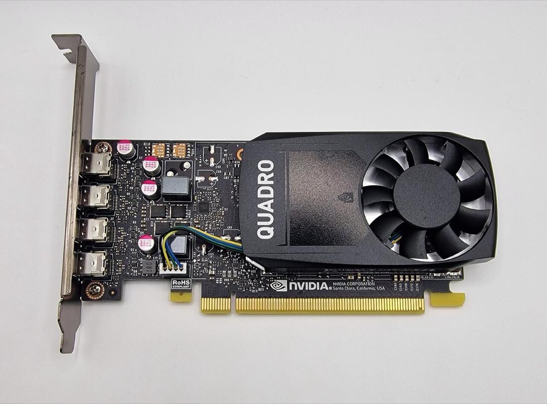 An Nvidia graphics processing unit with its cooling fan and circuit board exposed on a desk