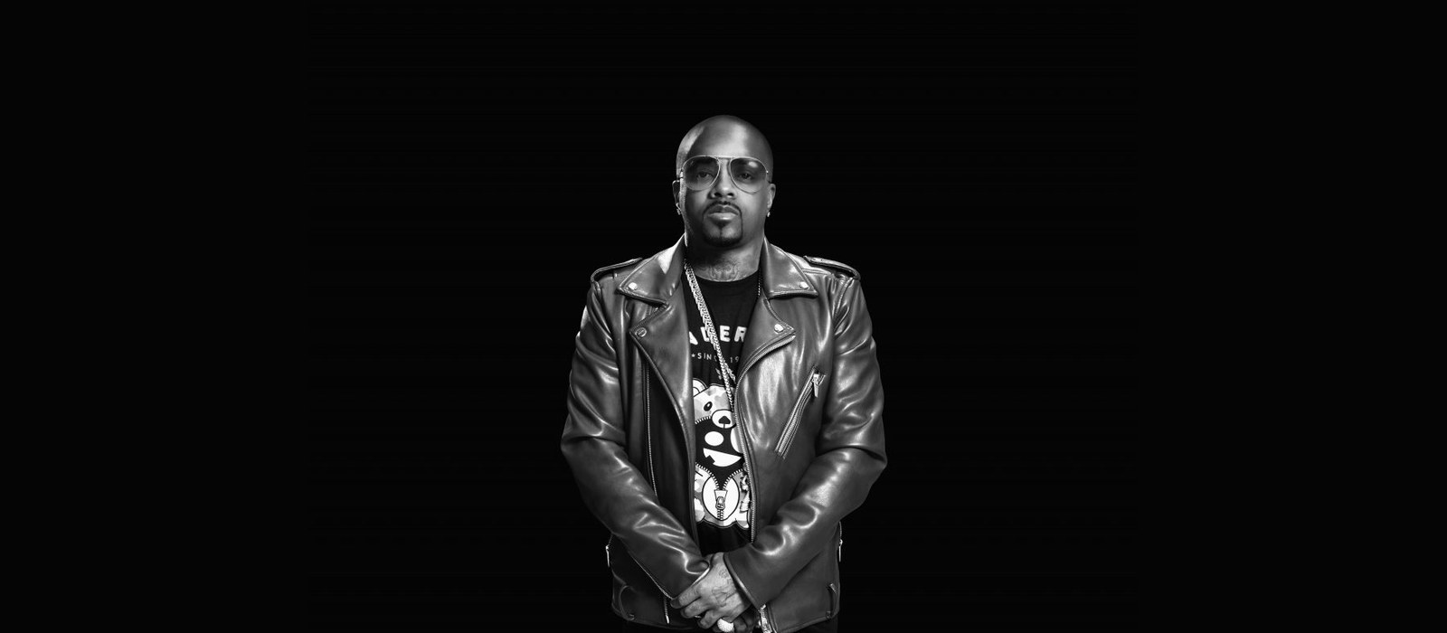 Black and white press portrait of Jermaine Dupri in a leather jacket, founder of So So Def Recordings