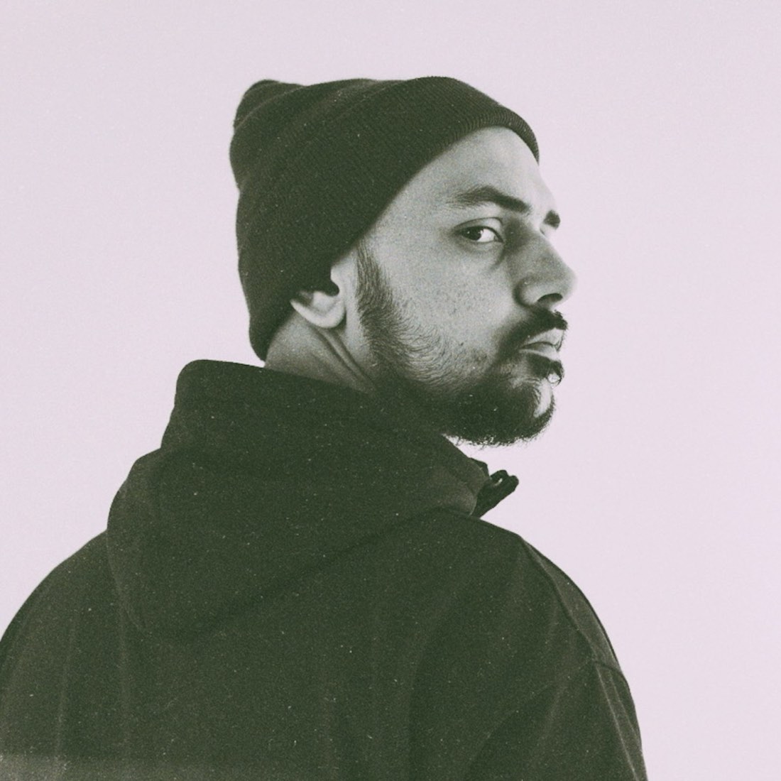 Nihil Young, Italian producer Mattia Marotta, in a beanie looking over his shoulder, whose Threads posts started the EDM callout wave