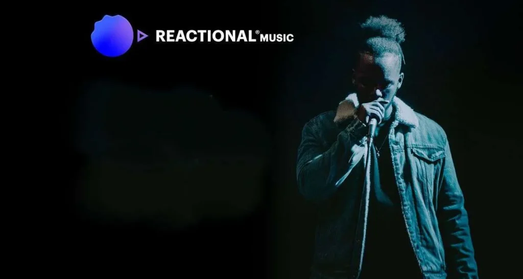 Reactional Music logo beside a vocalist performing into a microphone on a dark stage