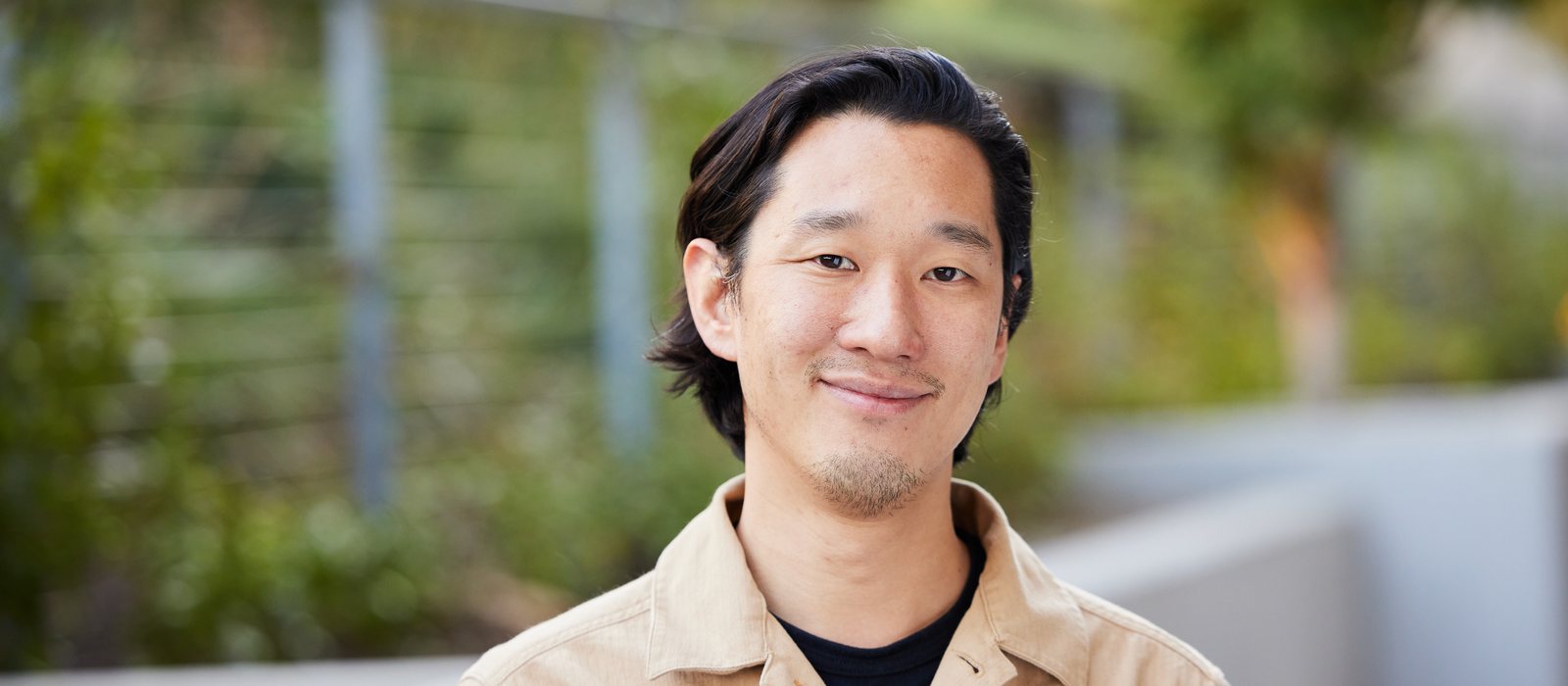 Michael Chua, Suno's new VP and General Manager of Suno Live Experiences, smiling outdoors