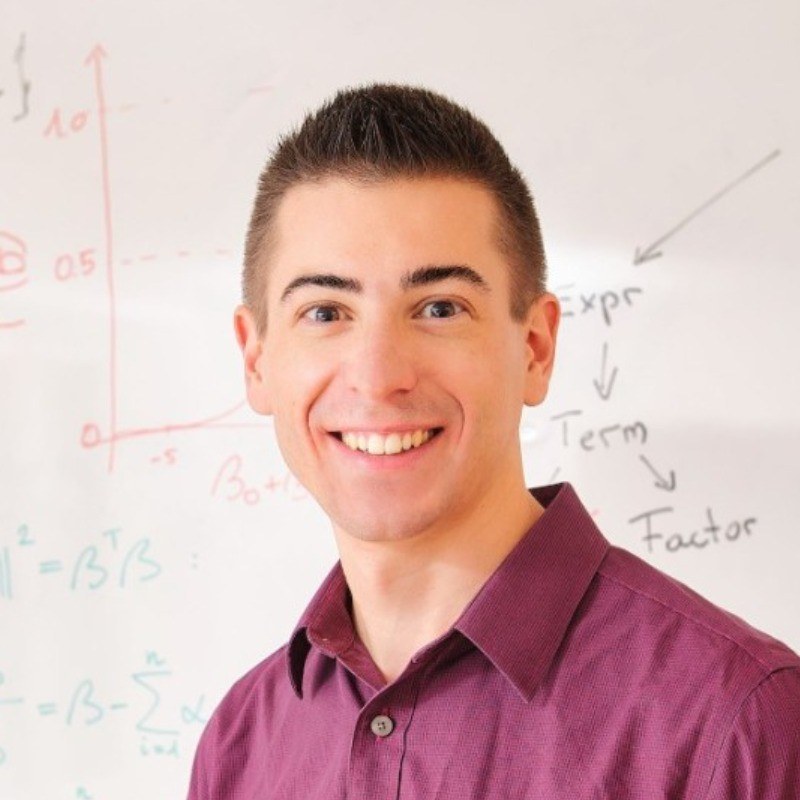Beat Shaper founder and ML engineer Taylor Peer in front of a whiteboard with model formulas