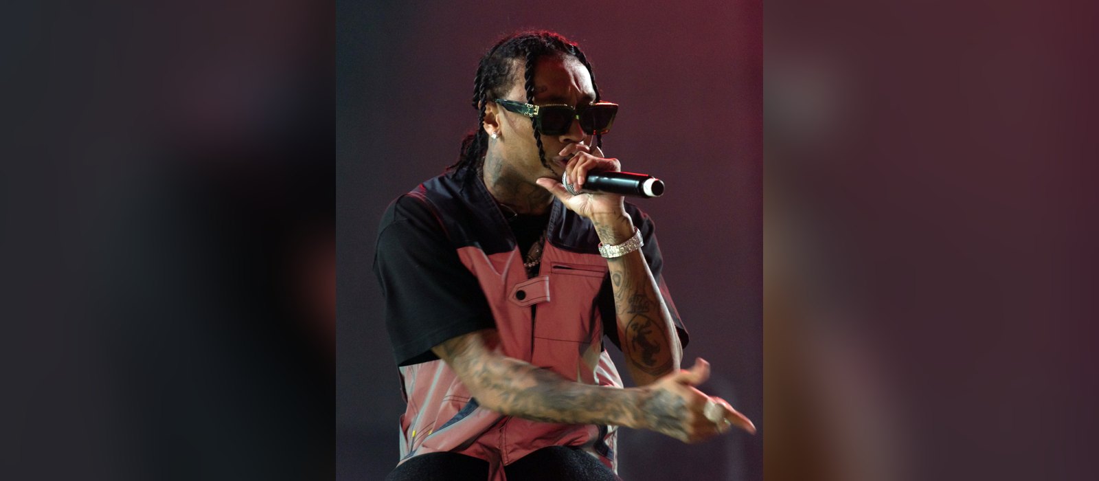 Tyga performing live with a microphone in sunglasses and braids at Openair Frauenfeld