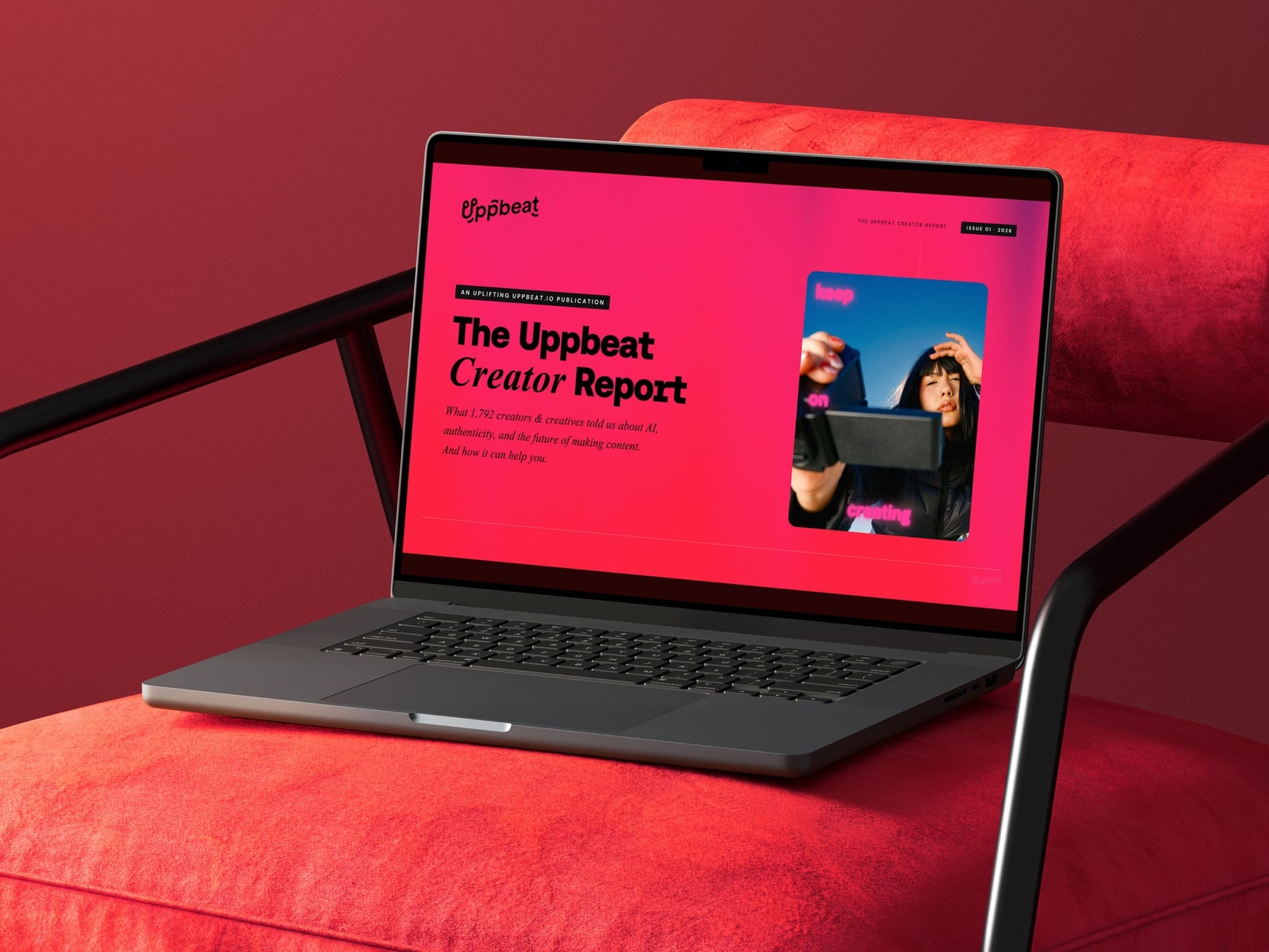 The Uppbeat Creator Report 2026 cover open on a laptop screen resting on a red armchair