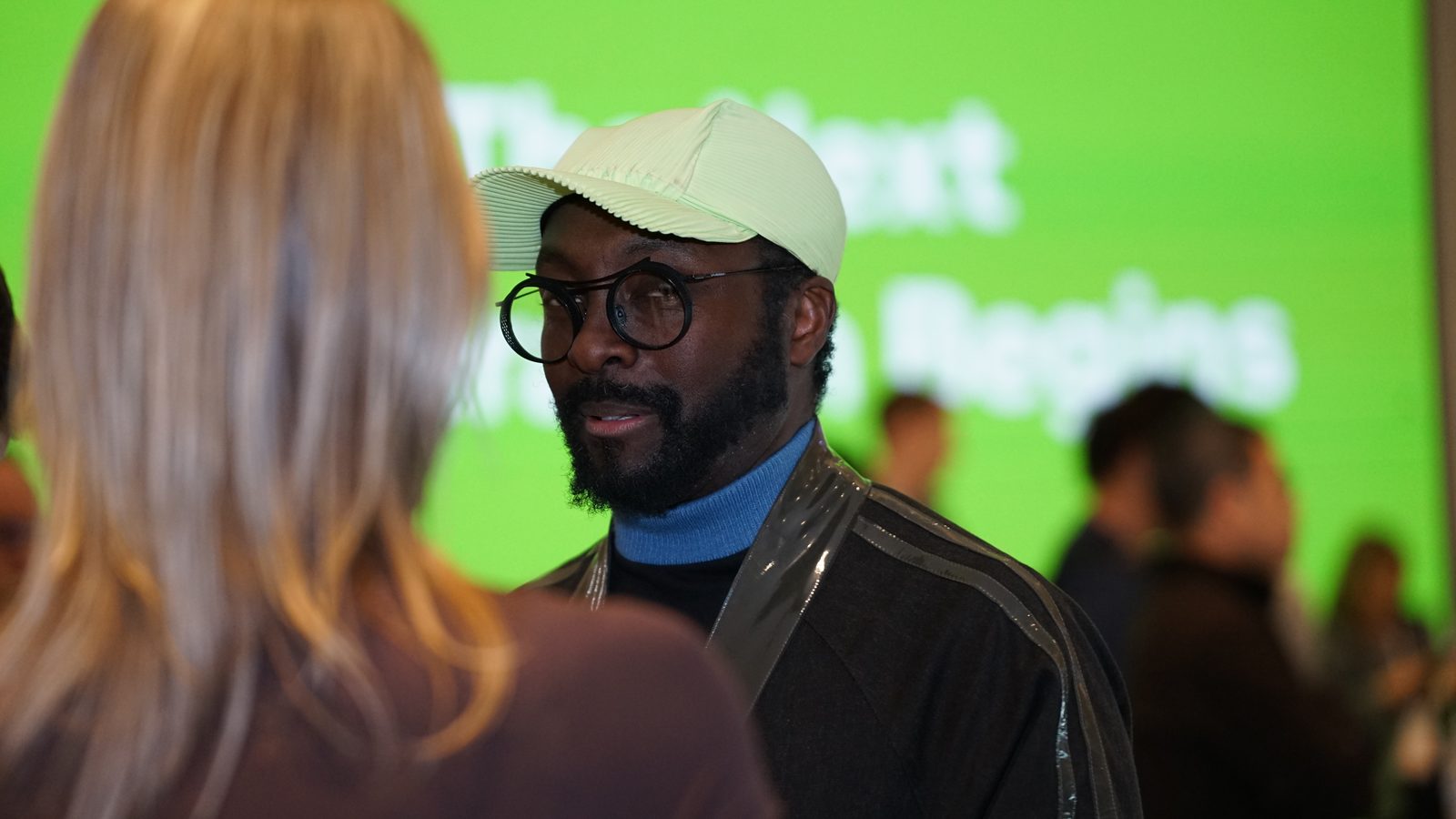 will.i.am in round glasses and a pale cap at CES 2026