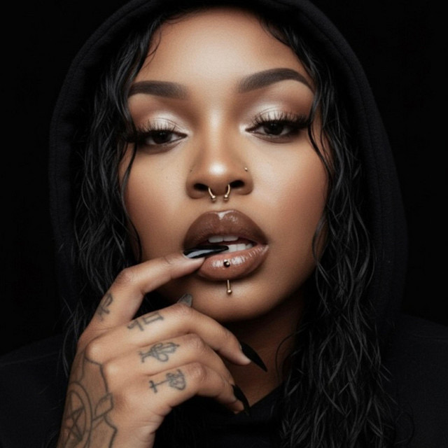 AI-generated portrait of the Yunna Serene persona — a woman in a black hoodie with septum and lip piercings and hand tattoos.