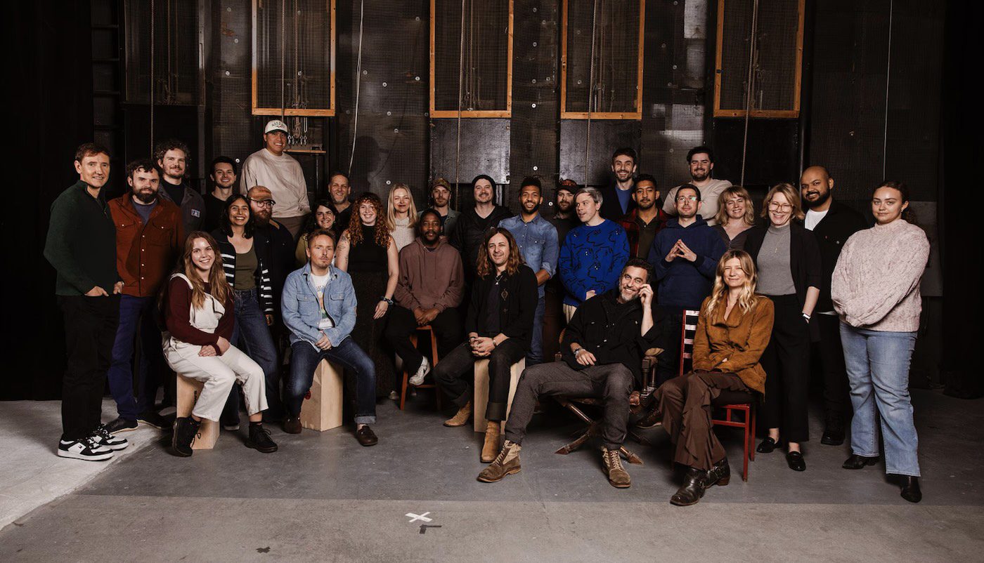 Moonvalley AI Team – A diverse group of people poses in a studio, representing the Moonvalley AI team.