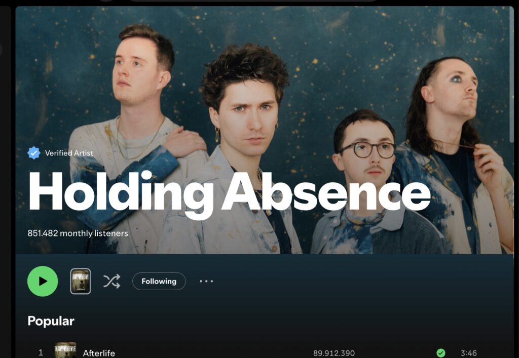 Holding Absence band Spotify banner, 850,000 listeners, blue background, four members.