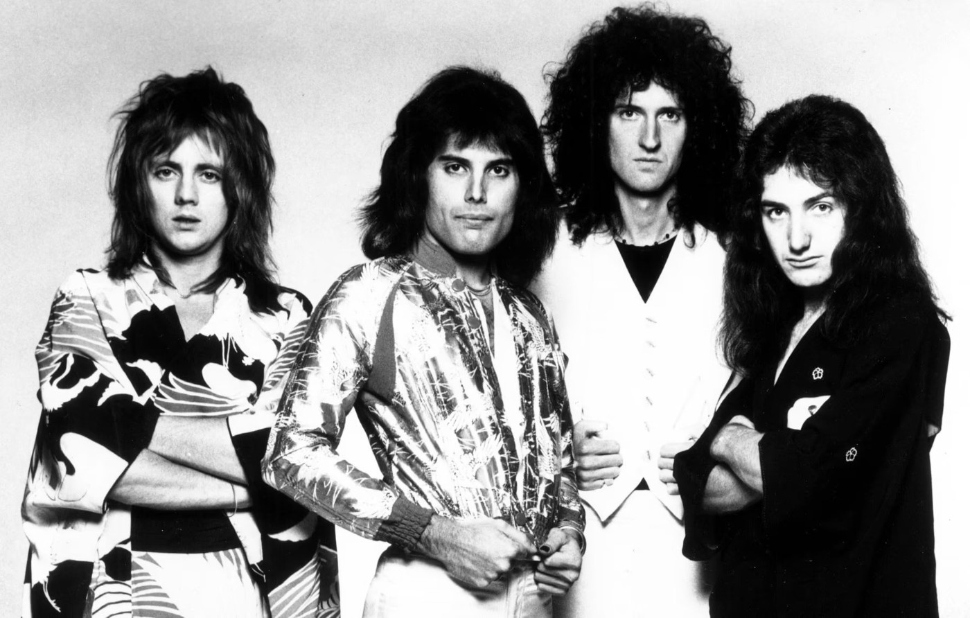 Queen poses confidently in stylish outfits for a 1975 publicity photo.