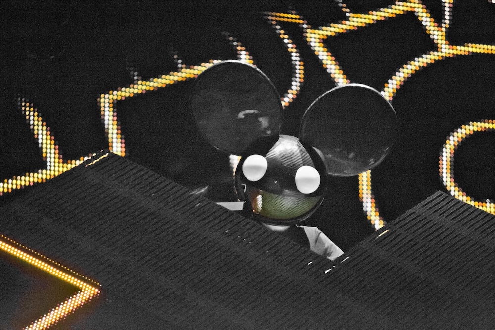 Deadmau5 performing at Rock in Rio Madrid 2012 with iconic mouse head helmet and LED stage setup.