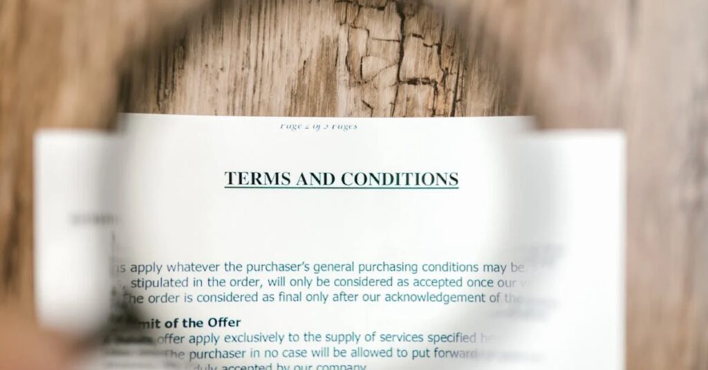 Close-up of a Terms and Conditions document page showing bold heading and blurred legal text against a wooden background.